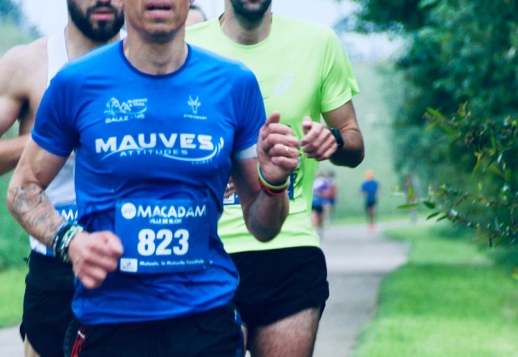 a group of men running down a road